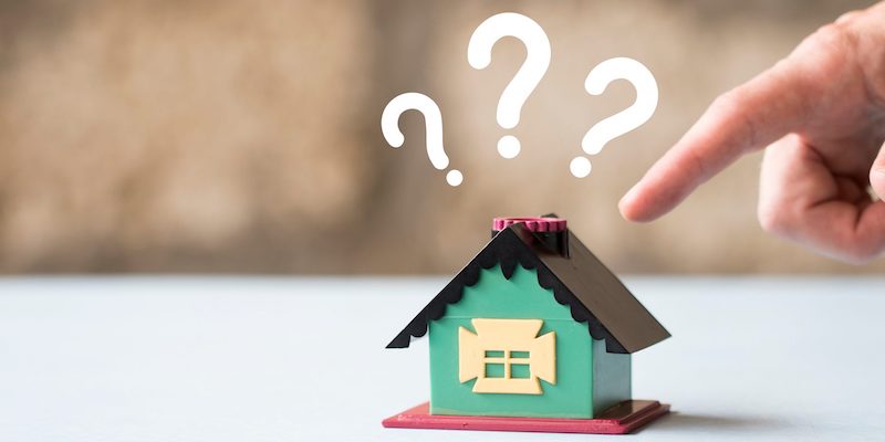 Do houses sell for less at auction? Image of a model house with question marks