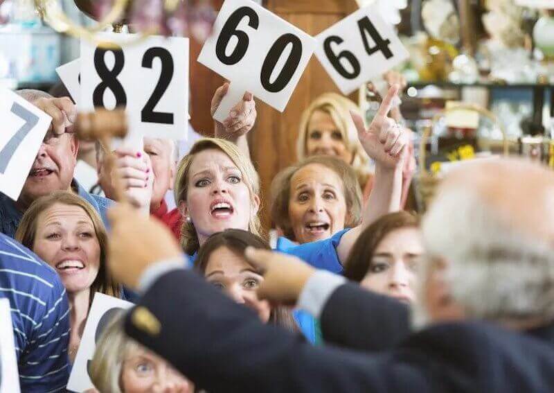 Image of bidders in a traditional auction