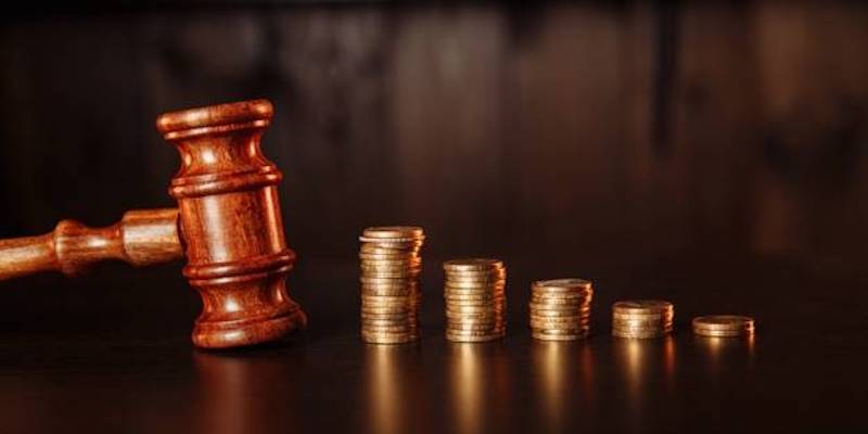 Image of an auction gavel with coins.