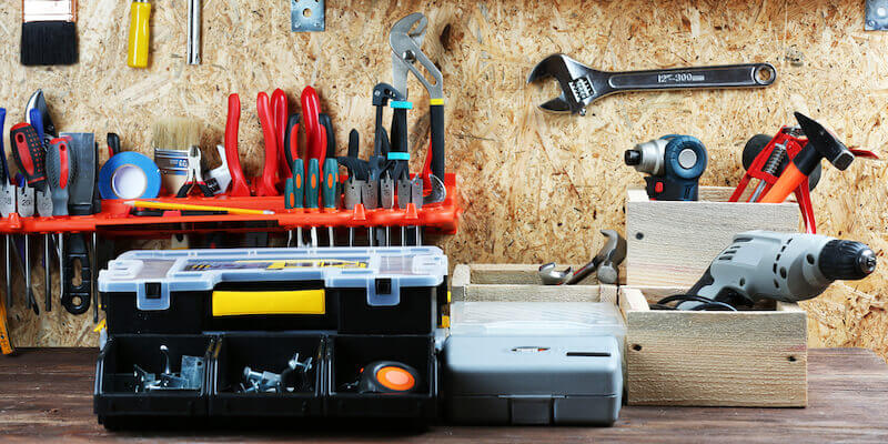 Image of a toolbox and other tools. Should you roll your sleeves up and prepare your home for sale by auction, or sell as-is?