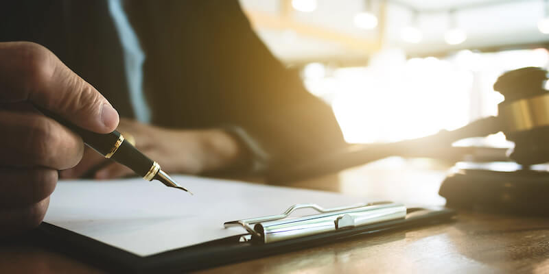 Image of a lawyer and a gavel. Buying property at auction is serious business, and you face legal consequences if you can't complete afterwards.