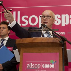 Image of Allsop auction's auctioneer at the podium. Live auction events can be a great way to immerse yourself in the auction world before your own property auction. 