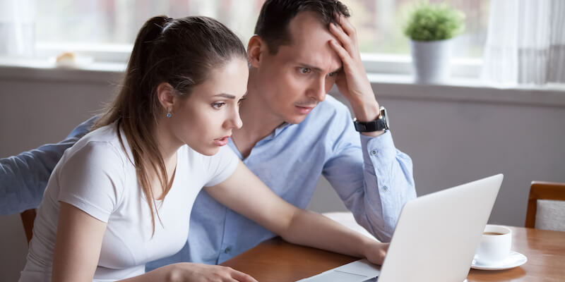 Man and woman receive email about house sale fallen through