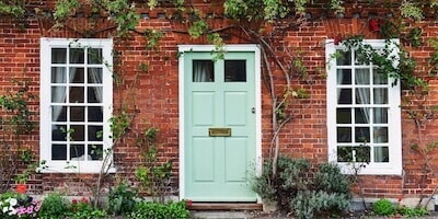 What are the initial costs when you inherit a property. View of a beautiful house exterior and front door.