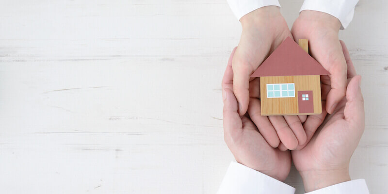 Father and daughter holding house object together. The Ultimate Guide To Selling An Inherited Property. 