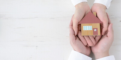 Father and daughter holding house object together. The Ultimate Guide To Selling An Inherited Property. 