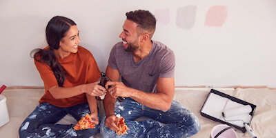 First-time buyers eating pizza after winning a property at auction