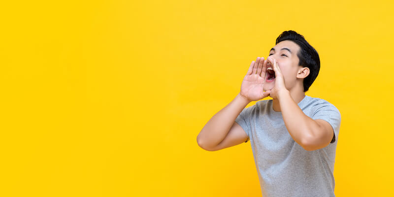 Young man announcing information with his hands to the mouth. Do you have to declare subsidence when selling your house.