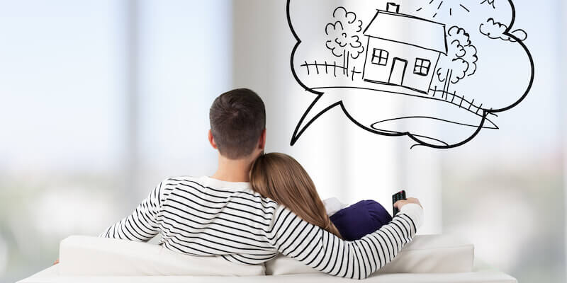 Couple on sofa contemplating house purchase. Should you buy a house with subsidence?