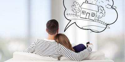 Couple on sofa contemplating house purchase. Should you buy a house with subsidence?