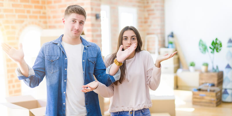 A couple looking confused in their home. Top 12 subsidence FAQs answered. 