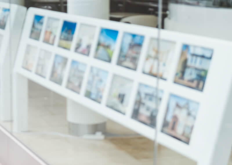 An estate agent window advertising houses for sale.