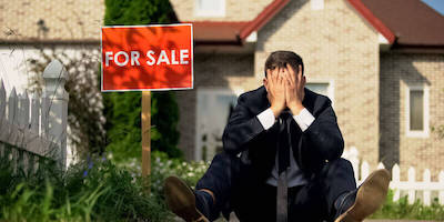 Upset man sat by for sale sign outside an underpinned house. Help! 6 Reasons why it is hard to sell a house that has been underpinned.