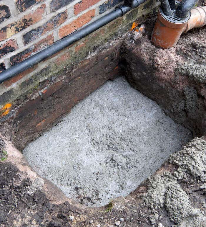An image of mass concrete underpinning carried out on a Victorian property.