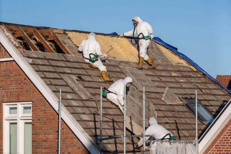 Asbestos safe removal and disposal on a roof of a house.