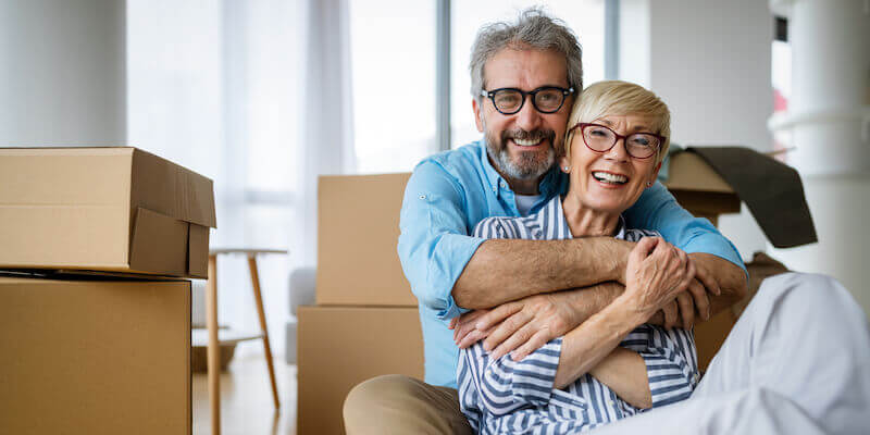 Portrait of happy senior couple selling home quickly and moving house. The Ultimate Guide to House Buying Companies.
