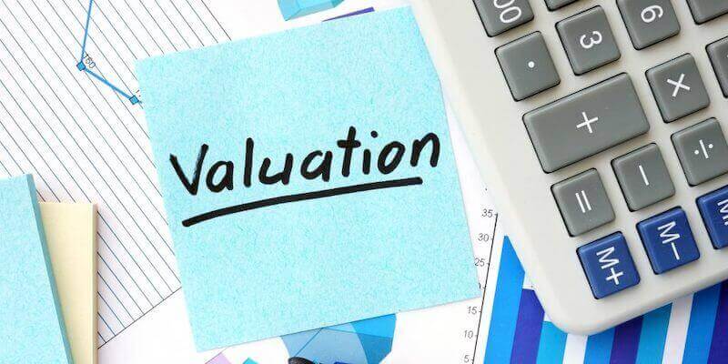 Image of the word "valuation" surrounded by graphs and a calculator